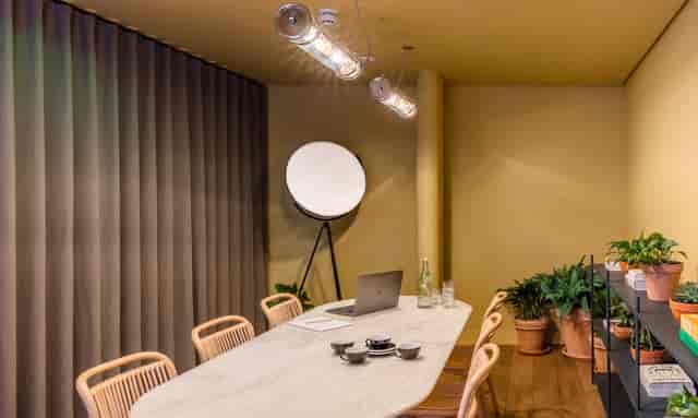Modern meeting room with sleek table, ideal for intimate gatherings and brainstorming sessions.