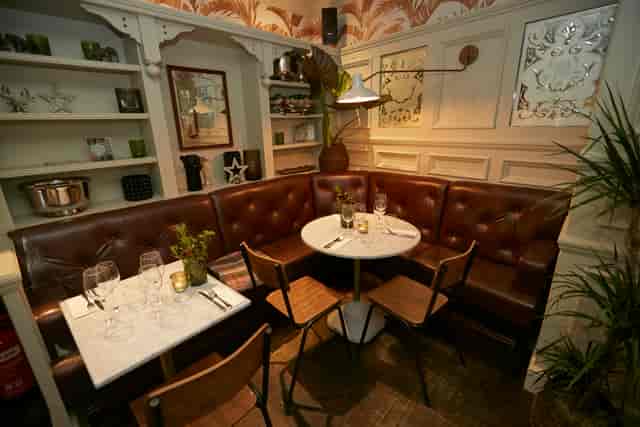 Cozy dining space with plush leather seating for private events and networking lunches.