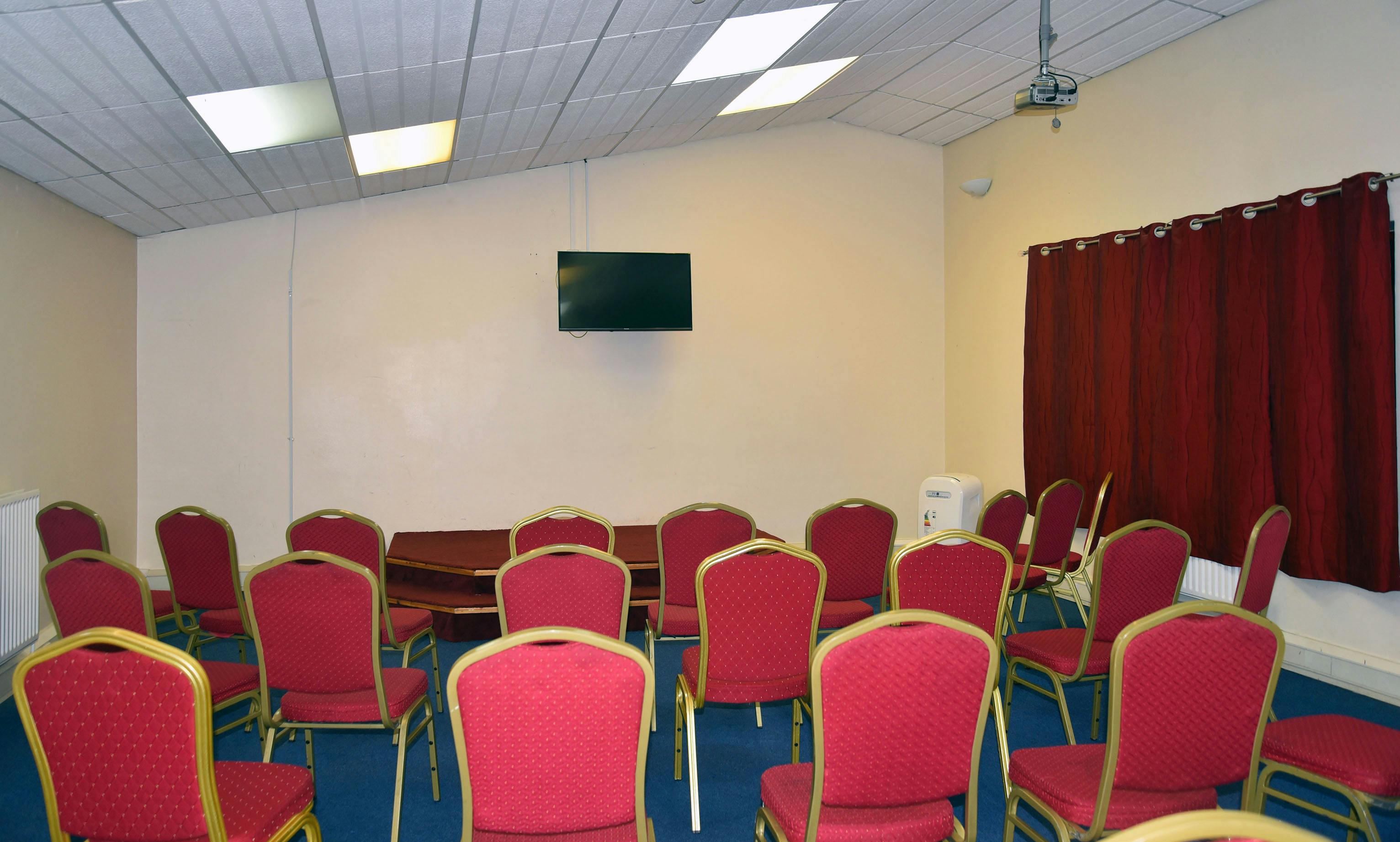 Mitcham Business Event Centre meeting room with red chairs, ideal for workshops and presentations.