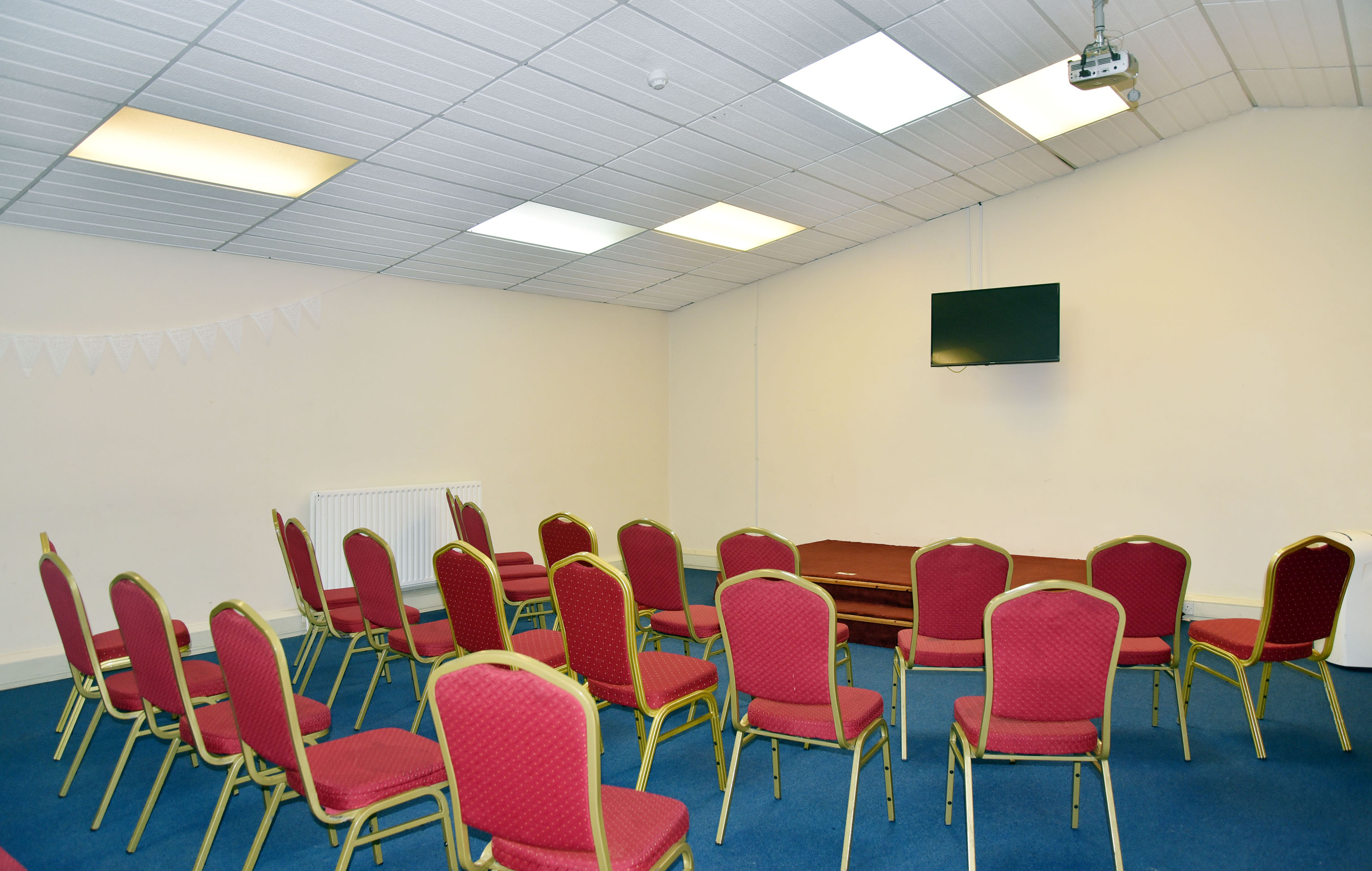 Mitcham Business Event Centre meeting room with red chairs, ideal for presentations and events. - Banner