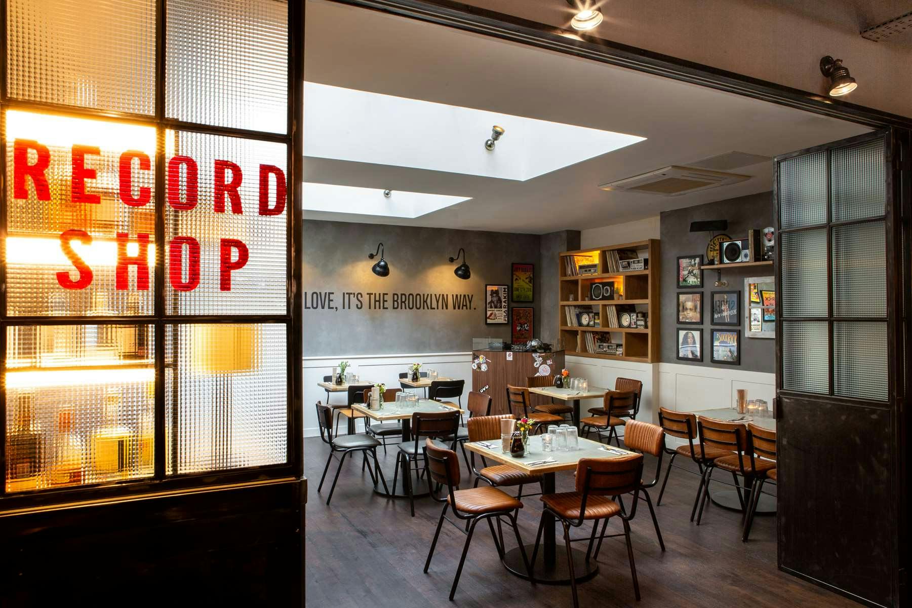 Stylish record shop café with warm lighting, ideal for creative events and meetings.