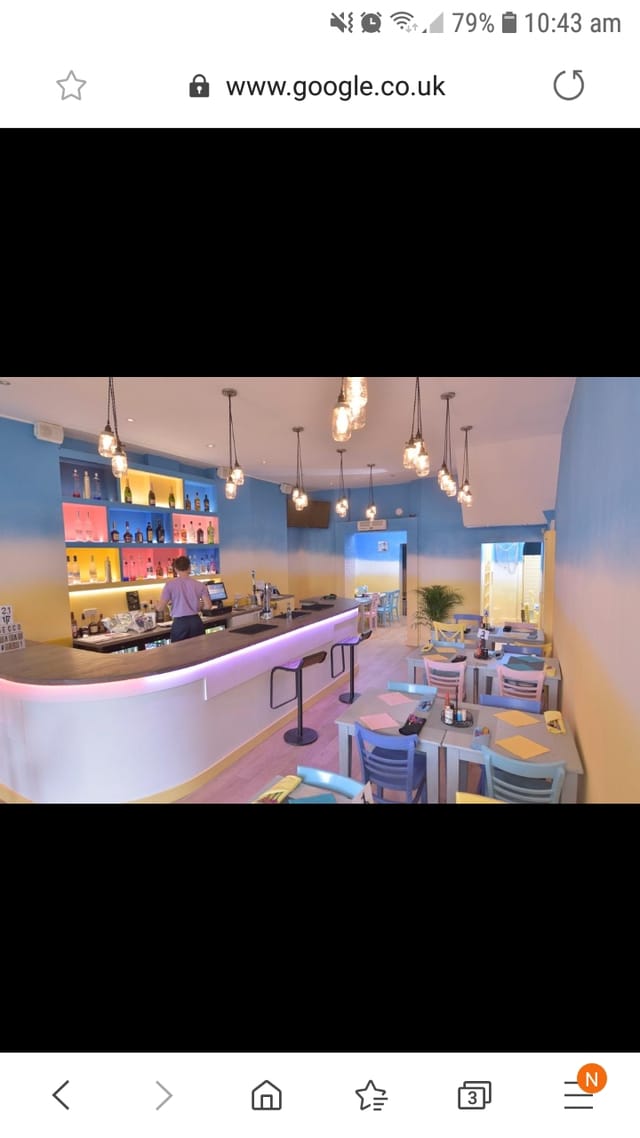 Vibrant modern café venue with colorful decor for casual meetings and events.