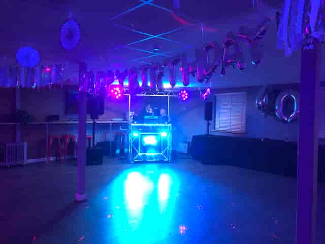 Vibrant birthday celebration venue with DJ booth and colorful decor at Lagoona Bar & Grill.