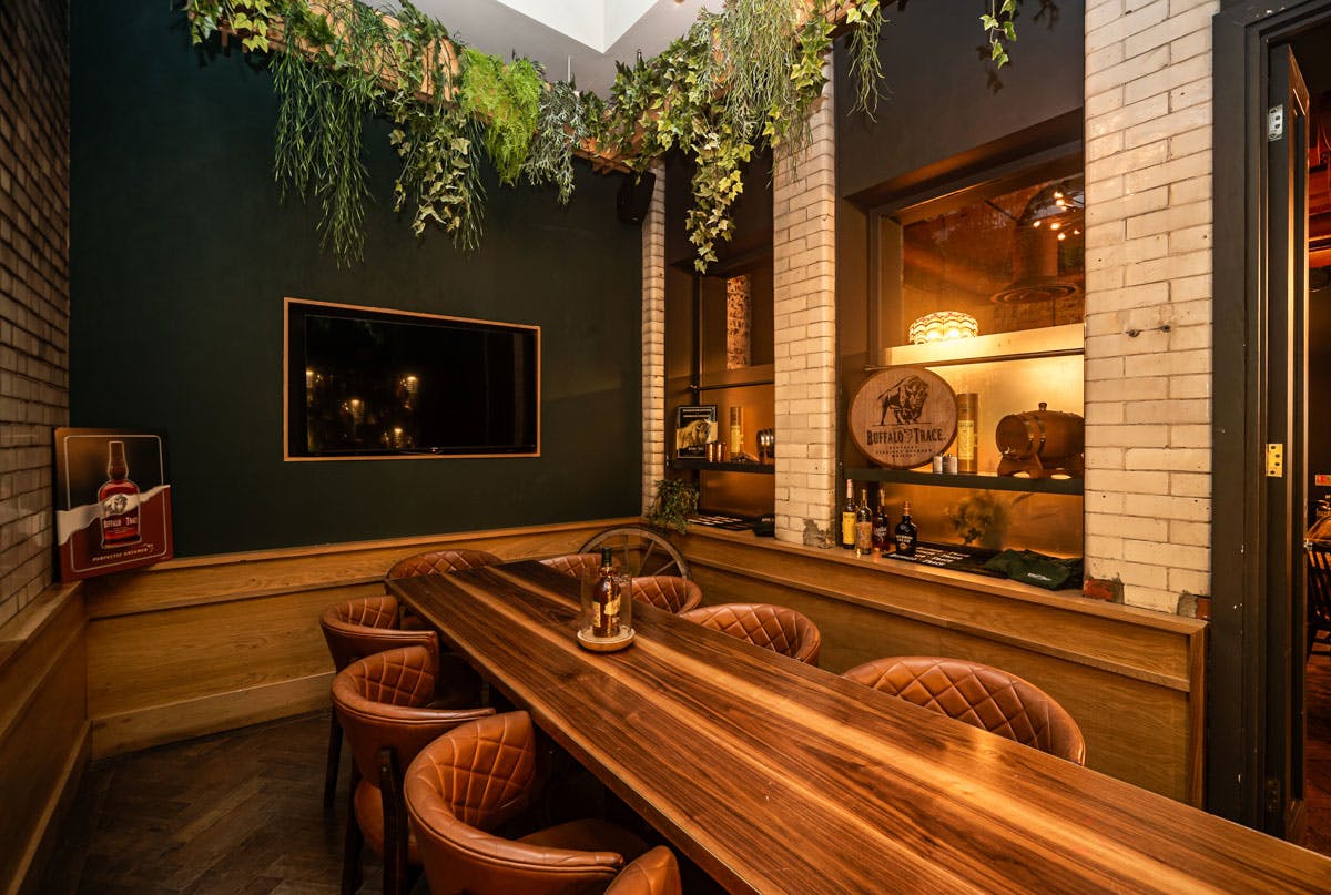 Private dining room at The Wren Tavern with a long wooden table for intimate events.