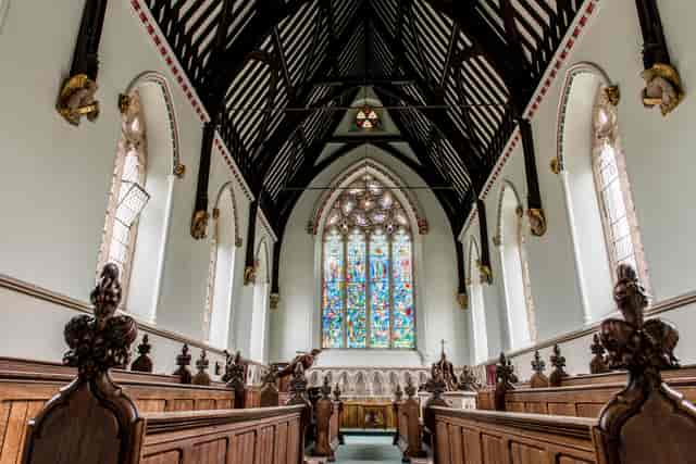 Elegant venue with vaulted ceilings and stained glass for ceremonies and gatherings.