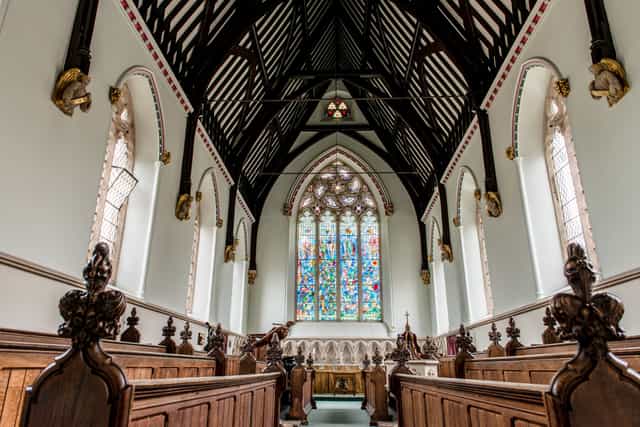 Elegant venue with vaulted ceilings and stained glass for ceremonies and gatherings.