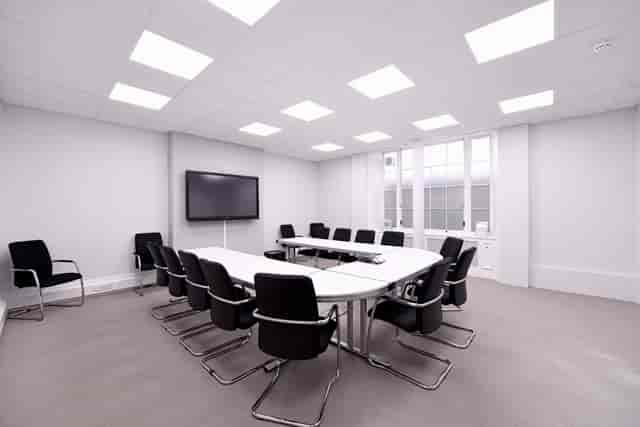 Modern conference room with oval table, ideal for corporate meetings and presentations.