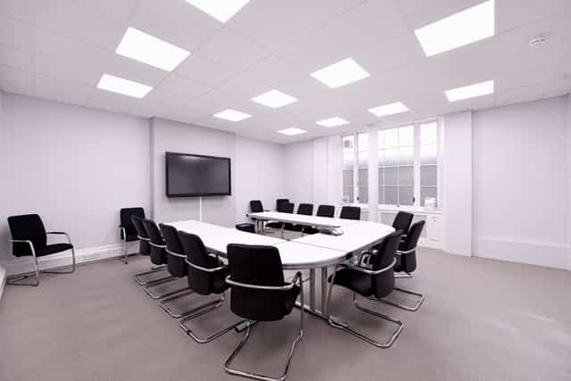 Modern conference room with oval table, ideal for corporate meetings and presentations.