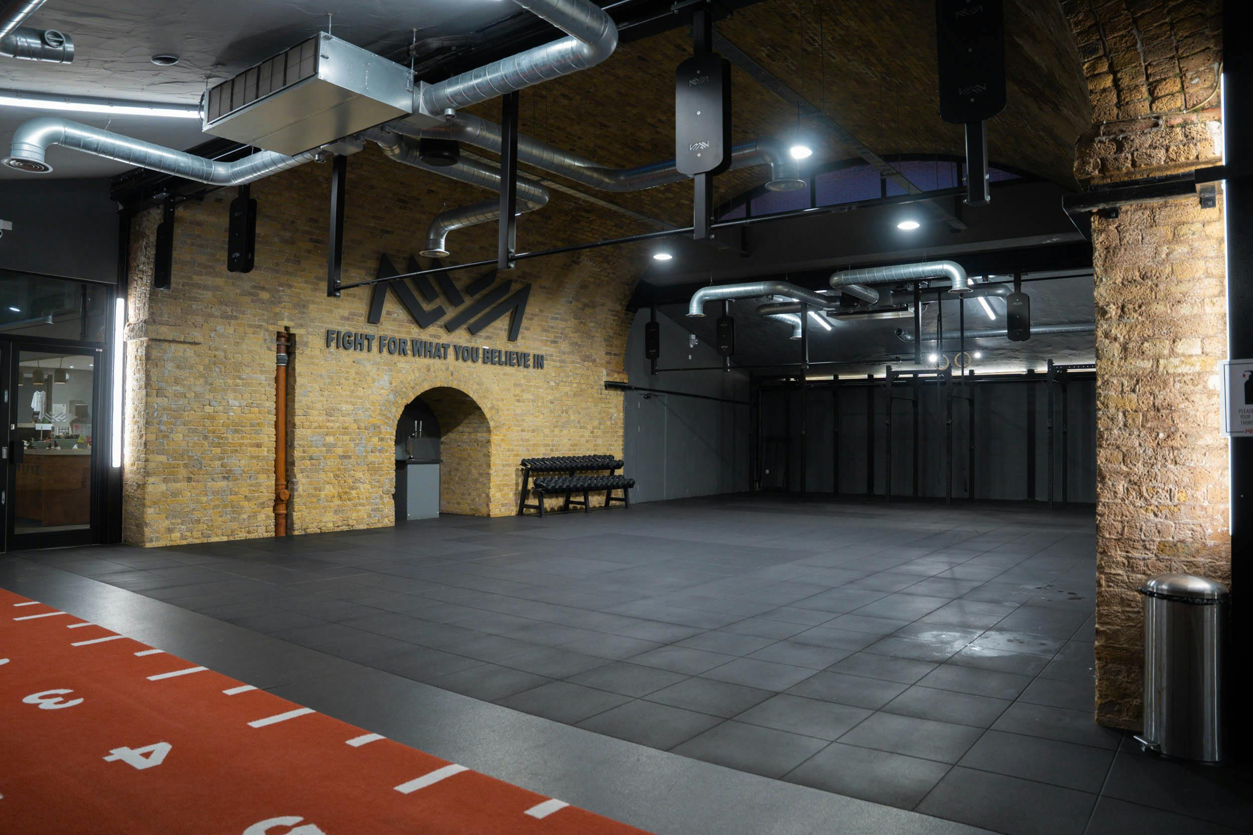 Versatile event space in CrossFit Putney with exposed brick for corporate and social gatherings.