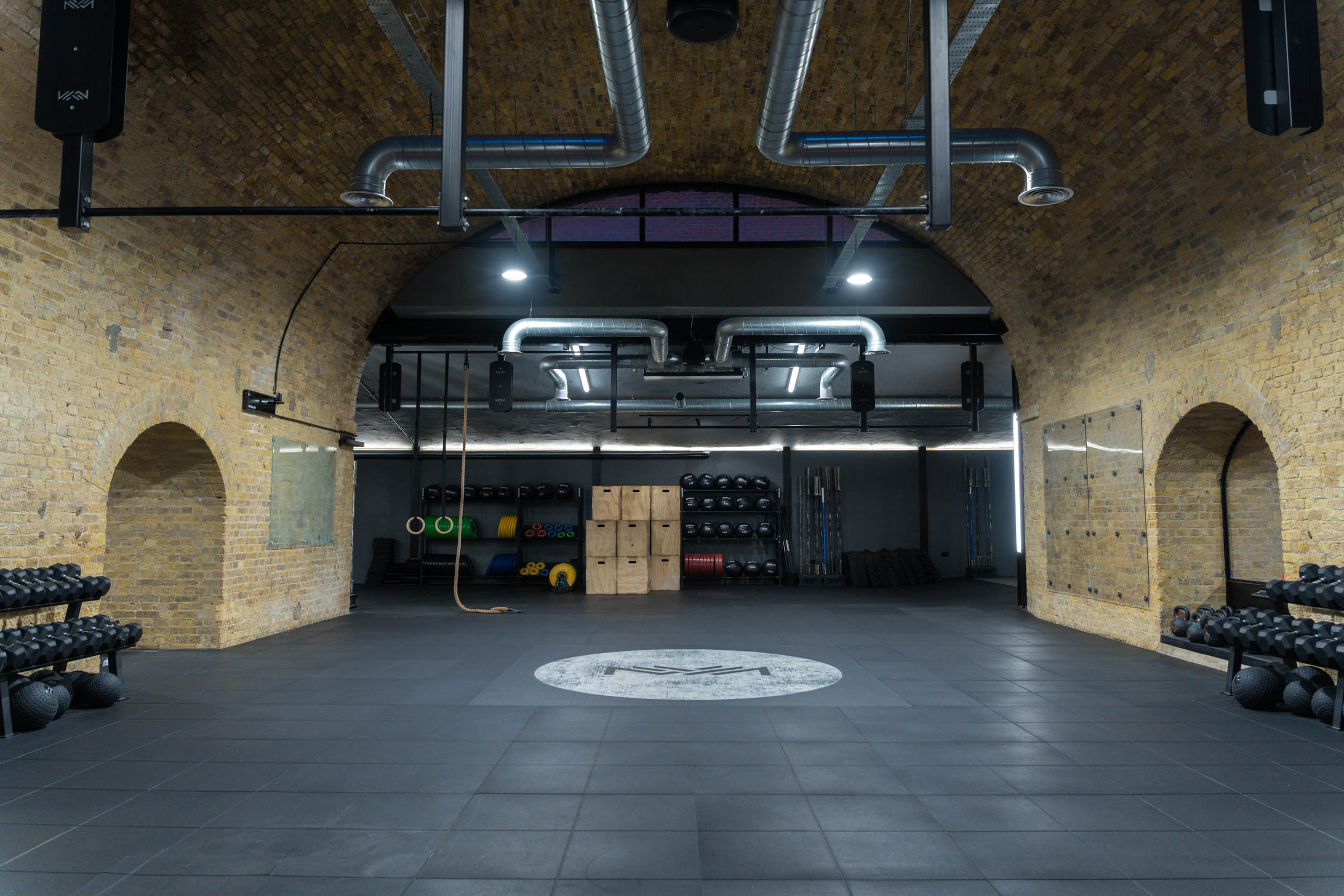 Spacious industrial fitness studio in CrossFit Putney for wellness retreats and events.