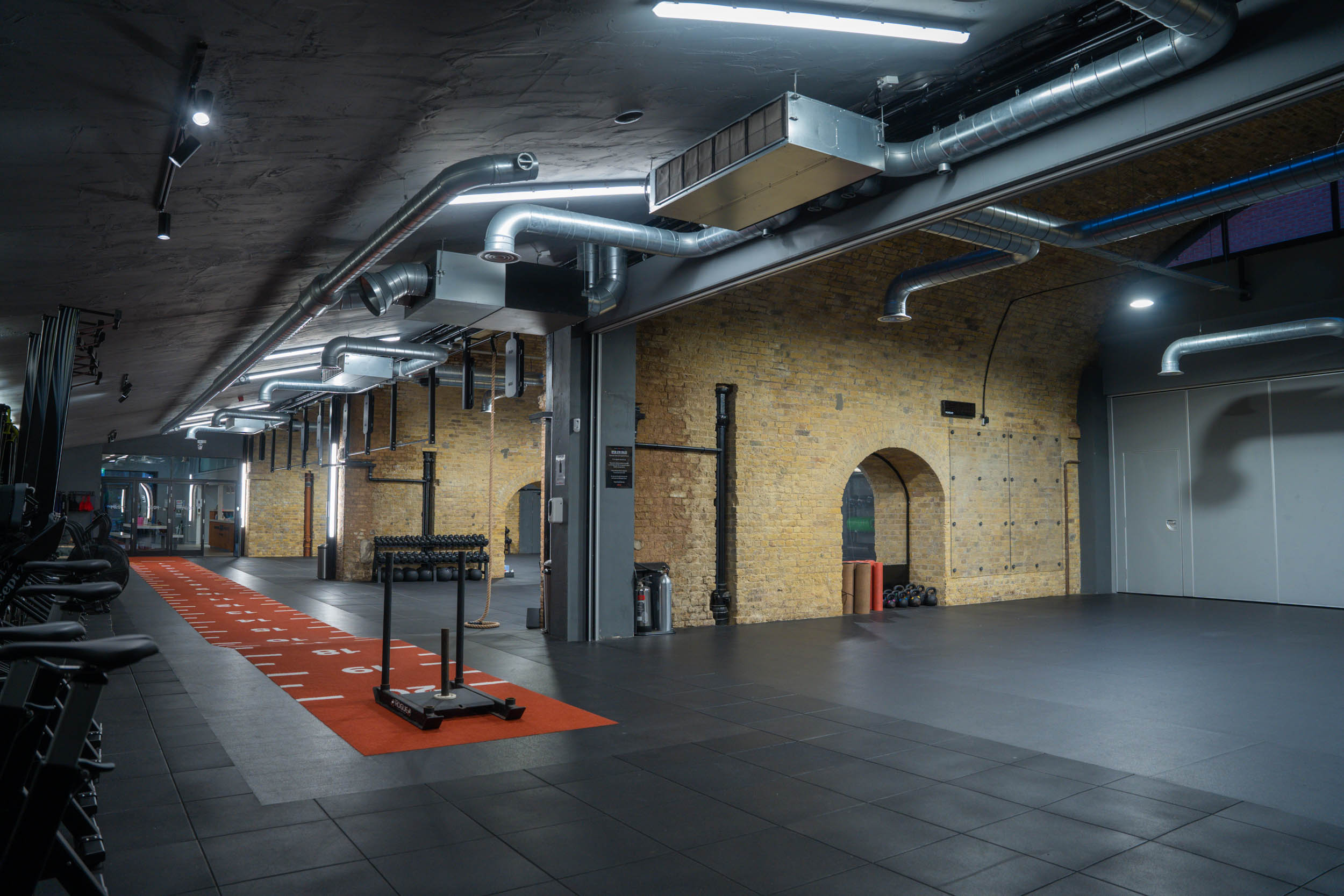 Versatile event space in CrossFit Putney with industrial design for fitness and workshops.