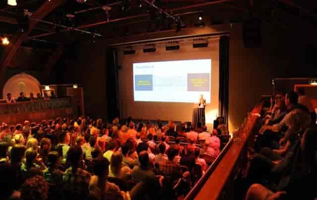 Engaging speaker at The Tabernacle conference with audience participation and networking.