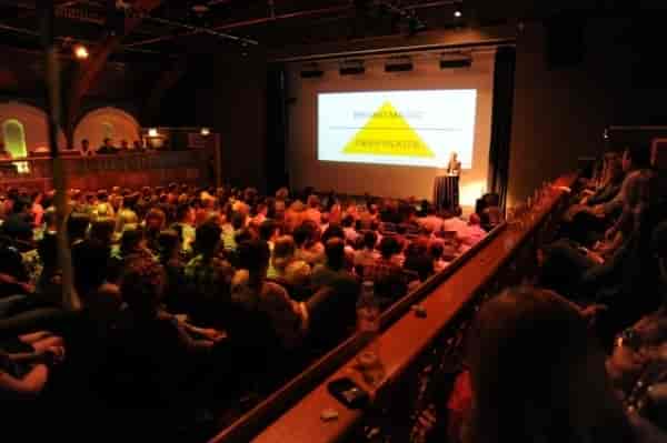 Conference speaker engaging audience in The Tabernacle, W11 with professional lighting.