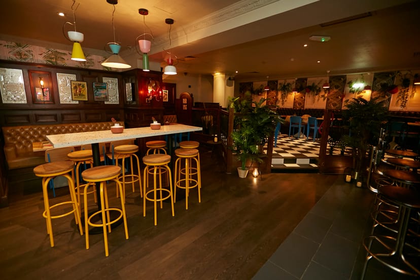 Versatile bar and restaurant event space with warm lighting for networking gatherings.