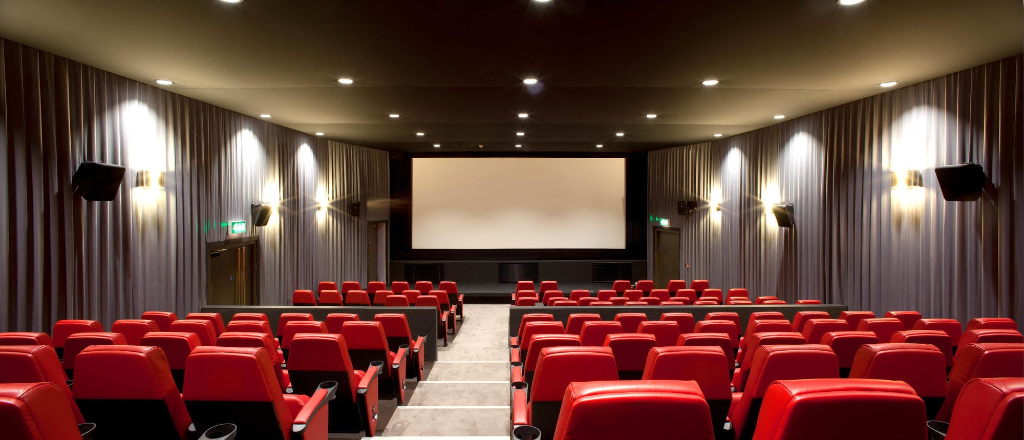 Modern auditorium with red seating at Barbican Centre for film screenings and corporate events.