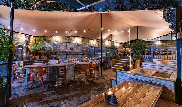 Outdoor event space with cozy seating, ideal for networking and social gatherings.