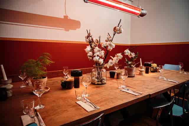 Private dining room with rustic table, ideal for intimate events and dinner meetings.