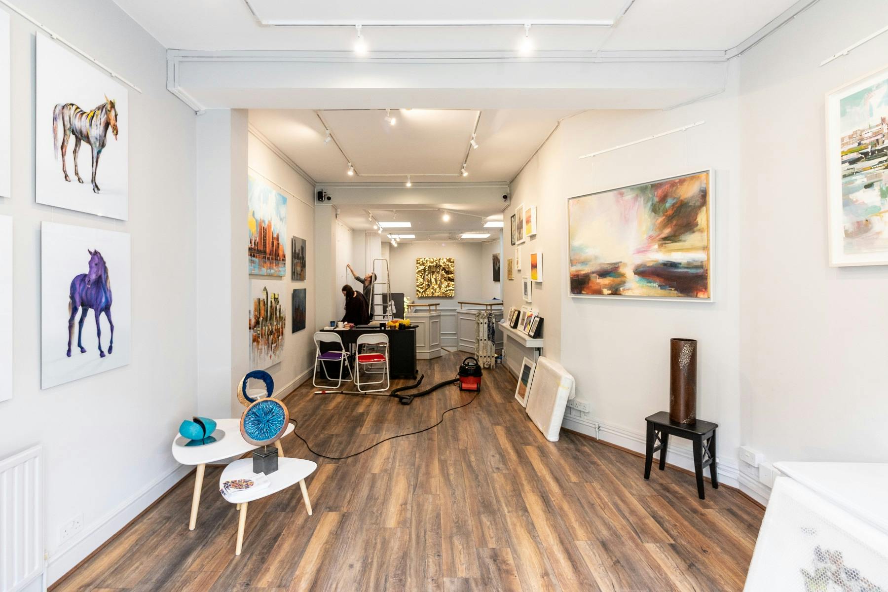 Versatile art gallery with polished wooden floors for exhibitions and corporate events.