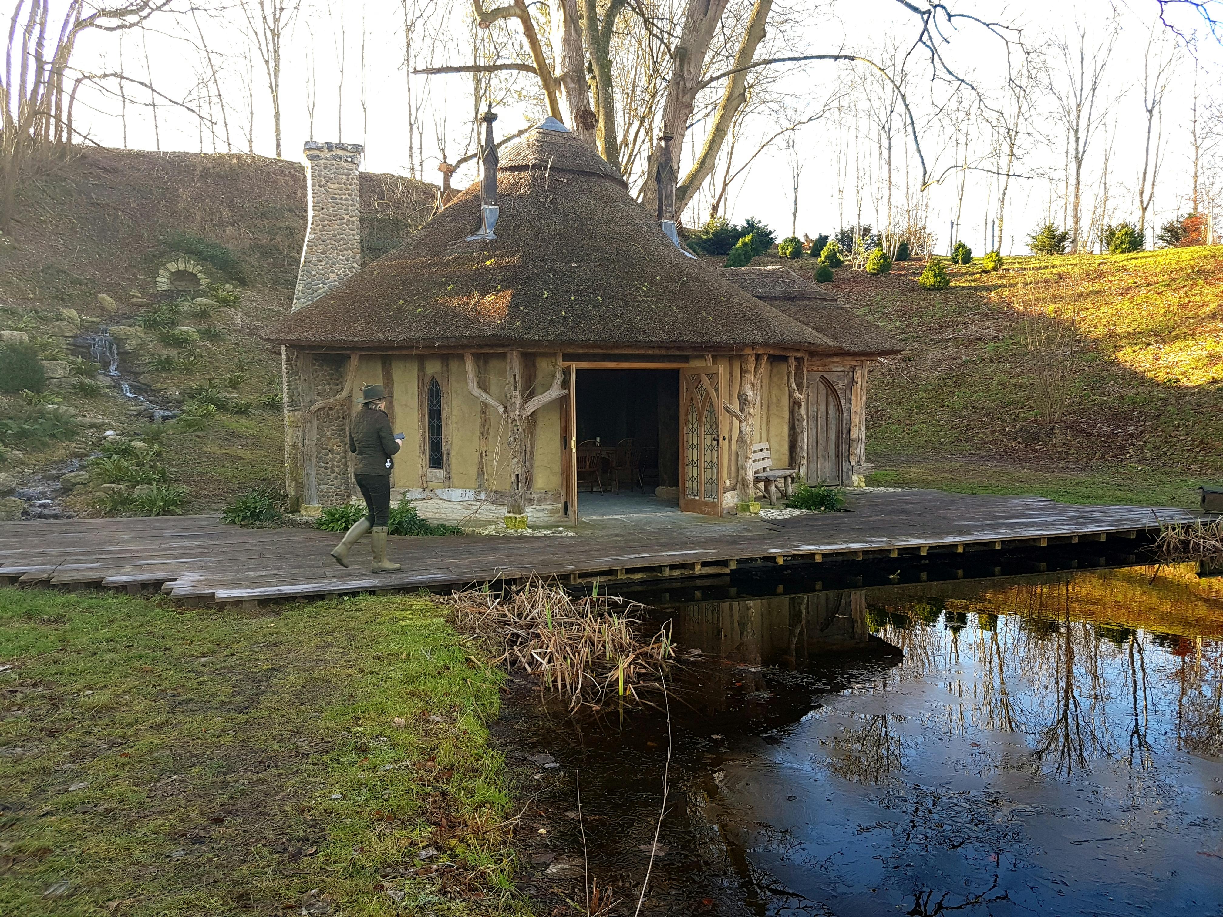 Woodland Lodge with thatched roof, ideal for retreats and team-building events.