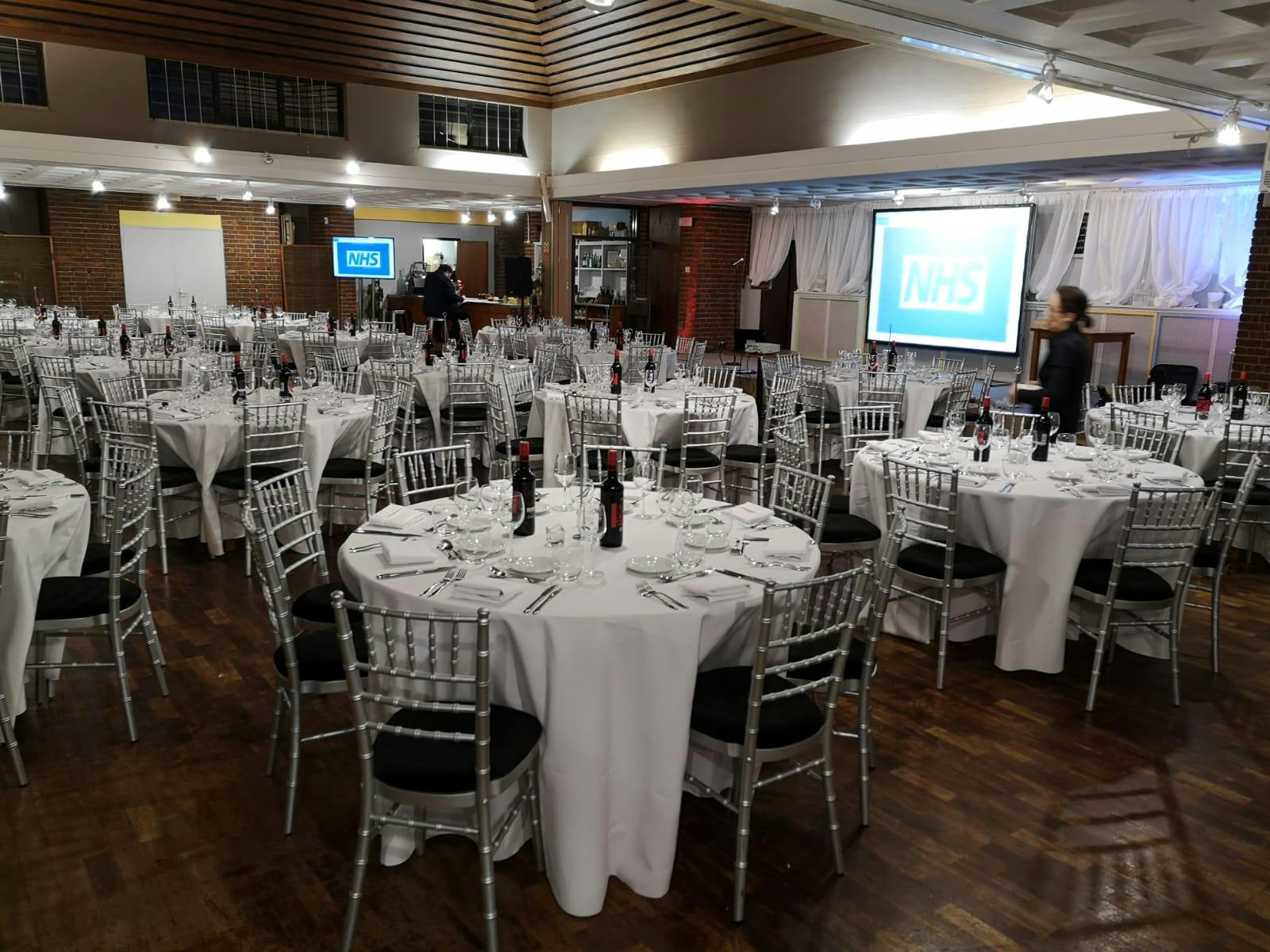 Elegant event space in Guildford Cathedral with round tables for corporate meetings.