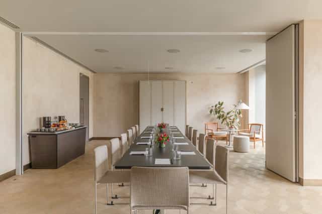 Modern meeting room at The Stratford, featuring a long table for professional gatherings.