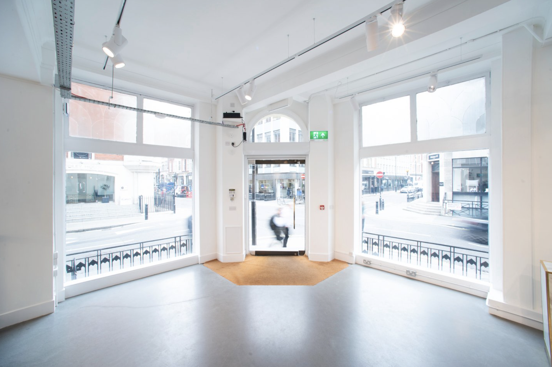 Bright event space with large windows at Whole Venue, ideal for meetings and workshops. - Banner