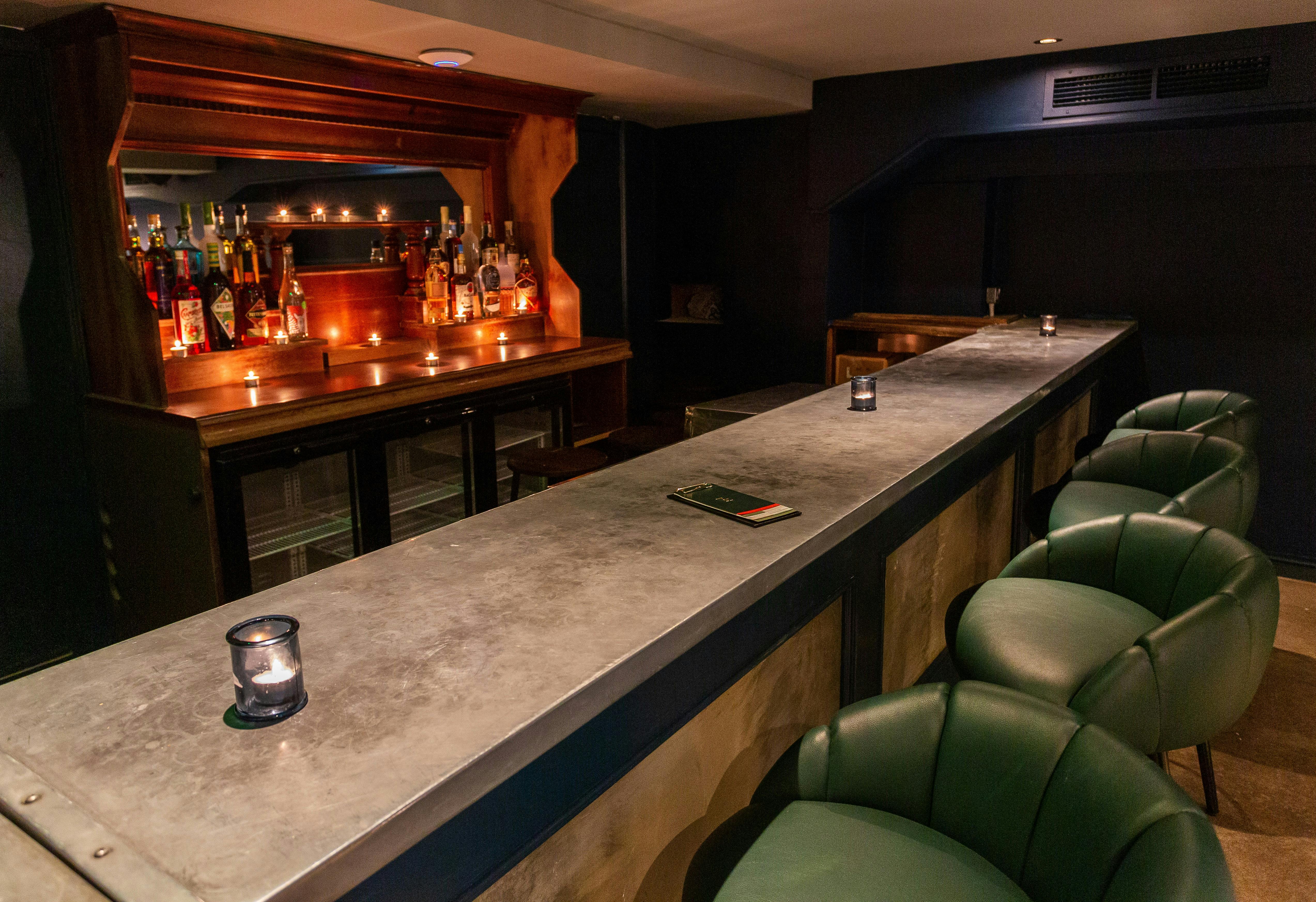 Stylish intimate bar with warm lighting, ideal for networking events and private gatherings.