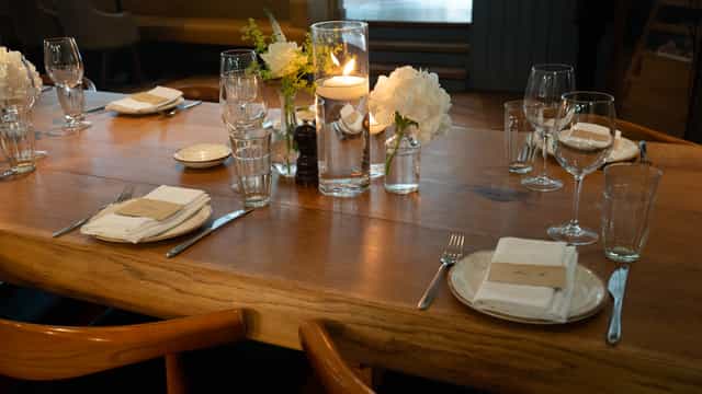 Semi-private dining room at TOZI Restaurant, elegant table setting for intimate events.