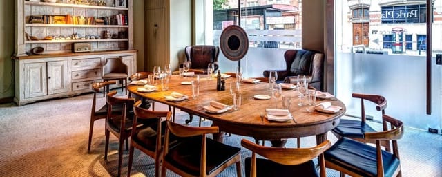 Semi-private dining room with wooden table, ideal for exclusive events at TOZI Restaurant.