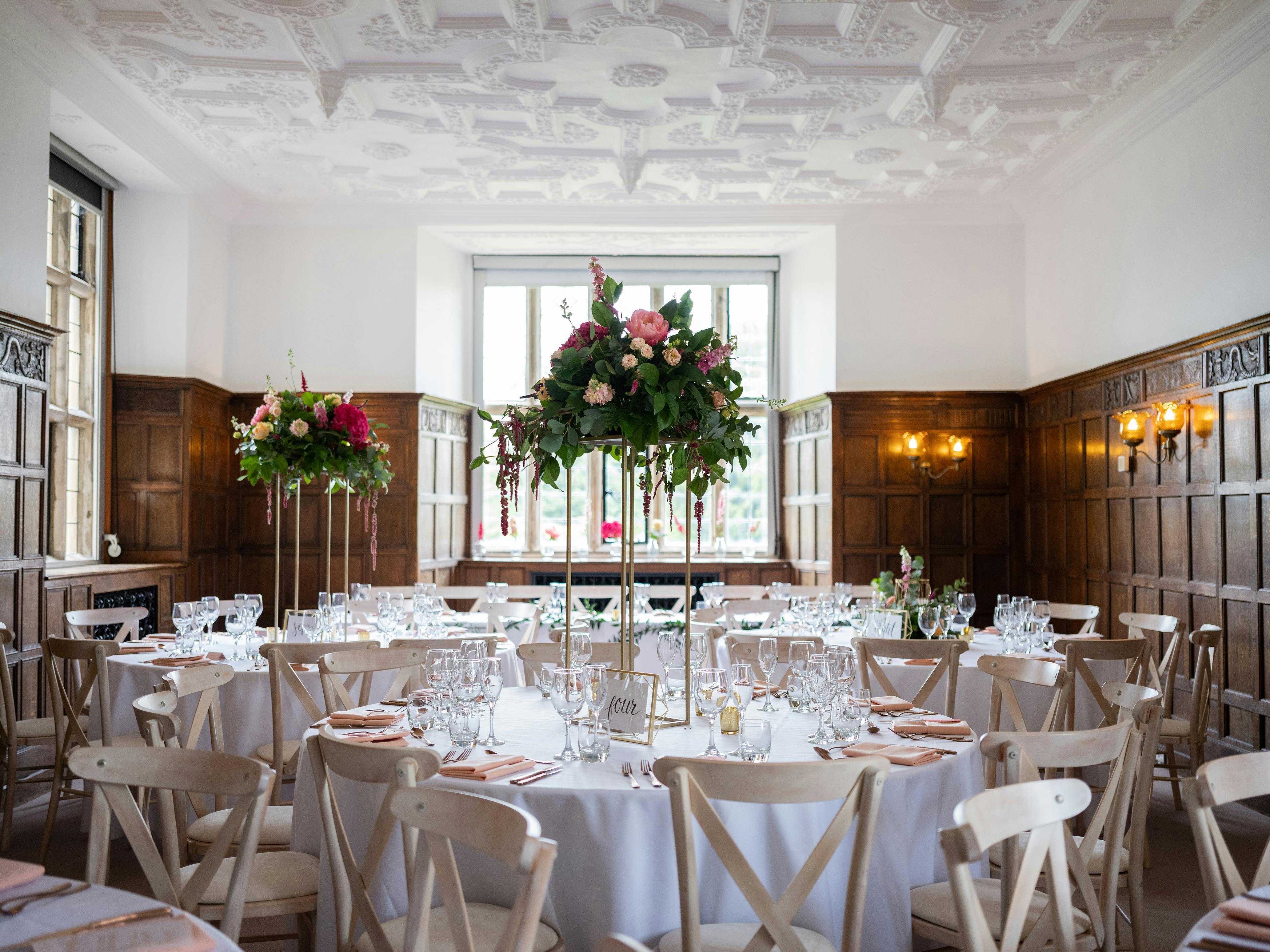 Elegant dining room at Wakehurst with floral centerpieces, perfect for weddings and events.