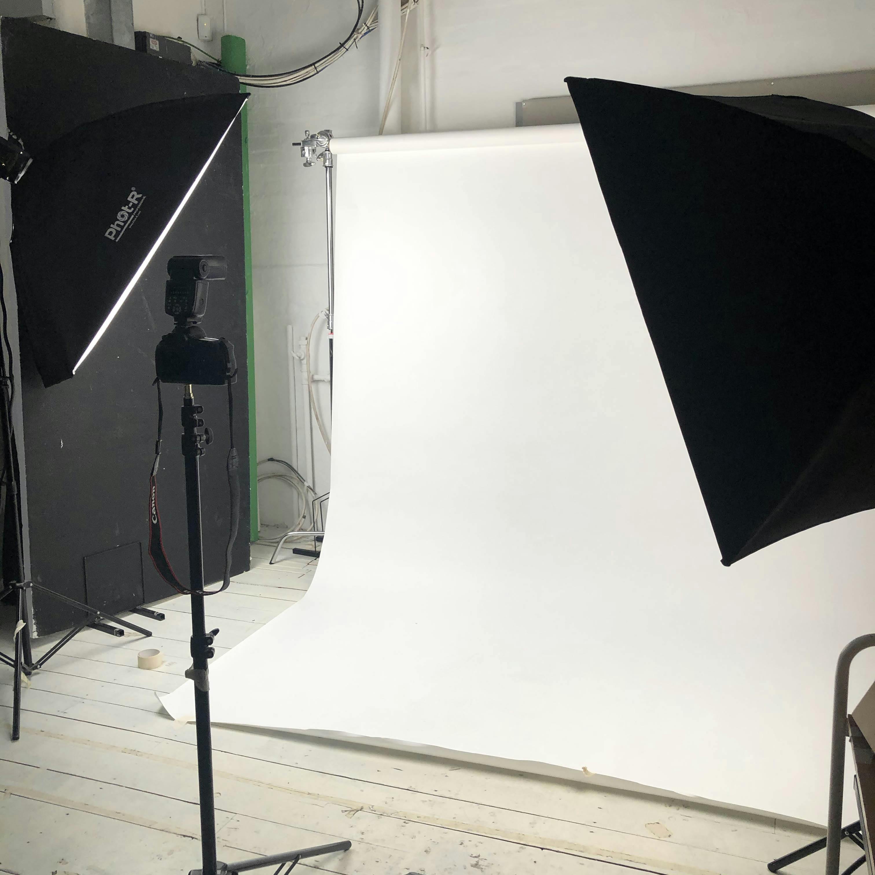 Professional photography studio with softbox lights for corporate headshots and events.