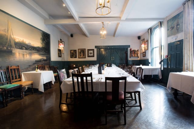 Semi-private long-table dining area at The Pilot for intimate corporate dinners and board meetings.