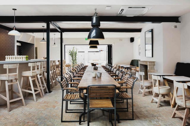 Industrial-chic semi-private dining area at The Pilot for corporate dinners and workshops.