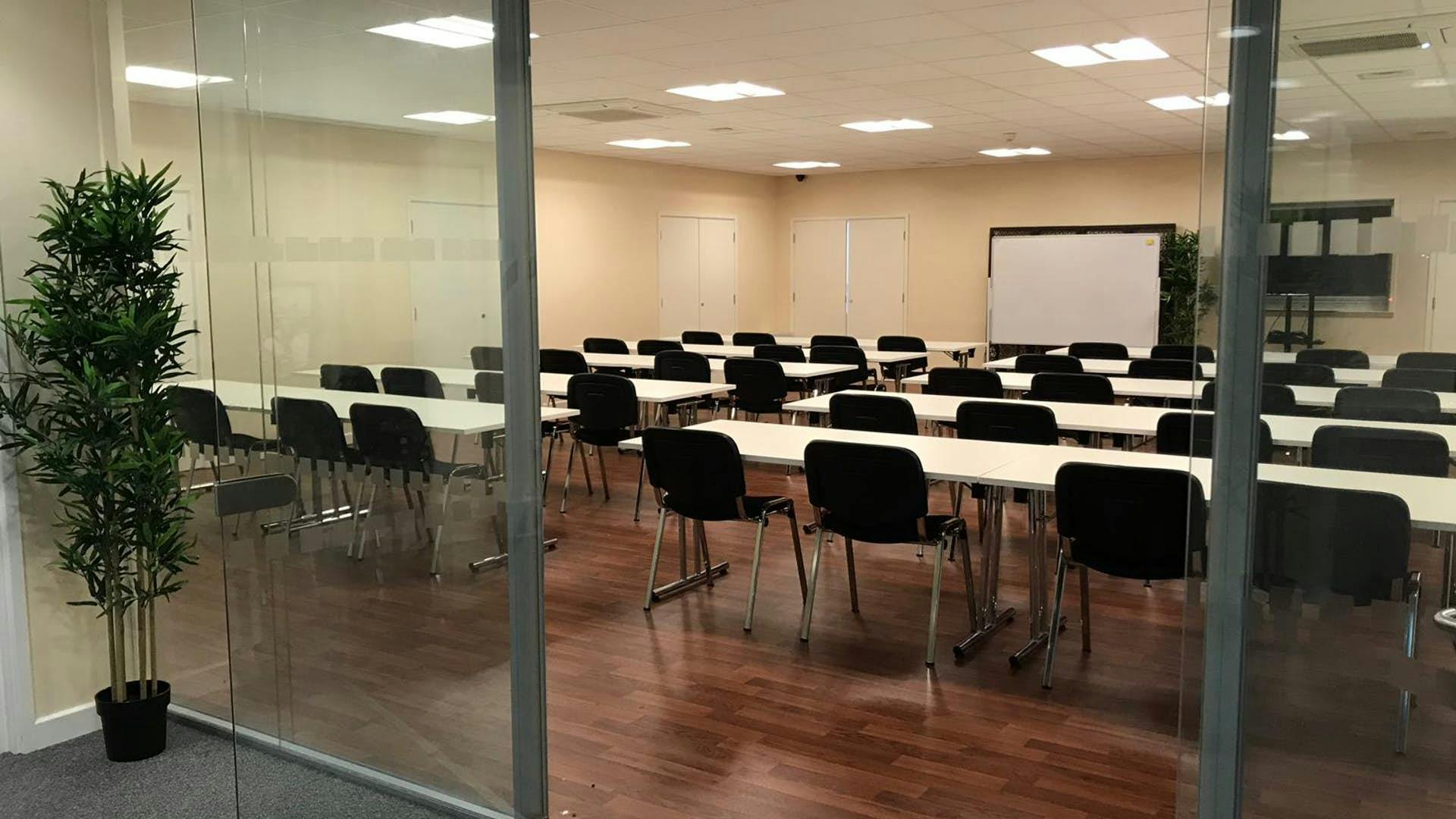 St Katherine Conference Hall with rows of tables, ideal for corporate training events.