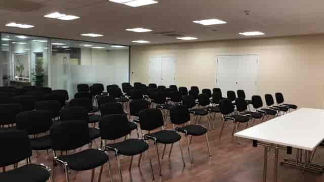 St Katherine Conference Hall with black chairs, ideal for workshops and presentations.
