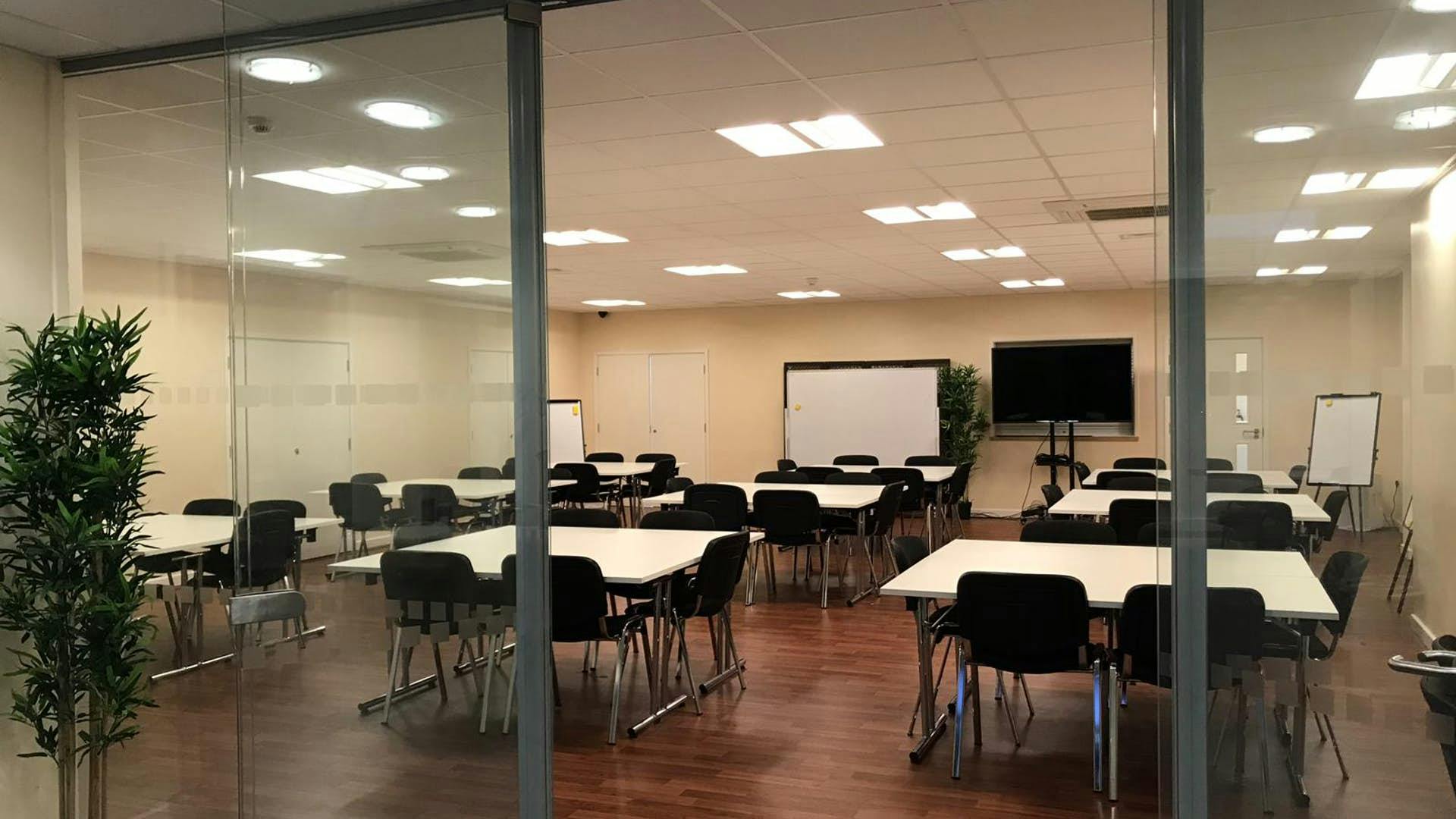 St Katherine Conference Hall: modern meeting room with glass walls for workshops and presentations.