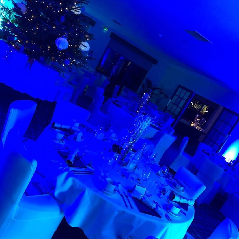 Elegant event space at Pyrford Golf Club with blue lighting for formal dinners and galas.