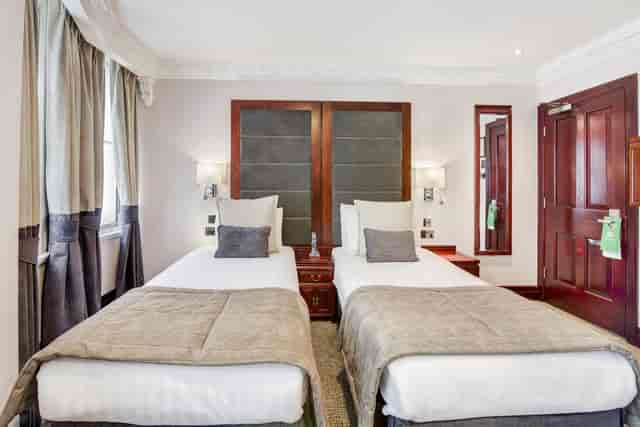 Portland Suite at Fitzrovia Hotel with twin beds, ideal for conferences and events.