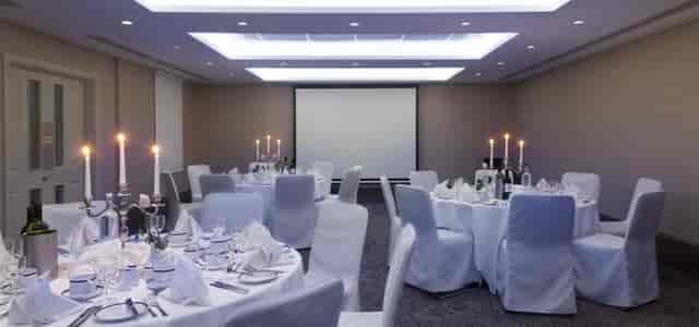 Langham Suite at Langham Court Hotel, elegant dinner setup for corporate events.