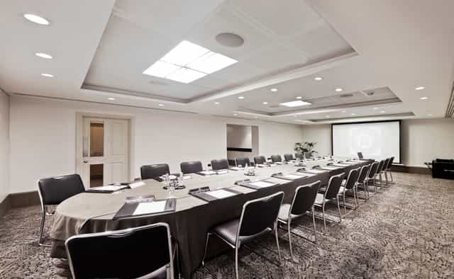 Langham Suite meeting room with oval table, ideal for corporate events and workshops.