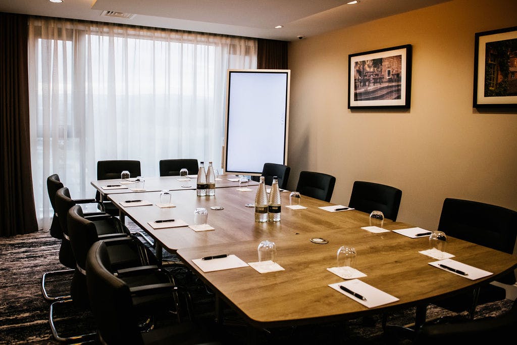 Woodland Boardroom at Crow Wood Hotel, featuring a large wooden table for meetings.