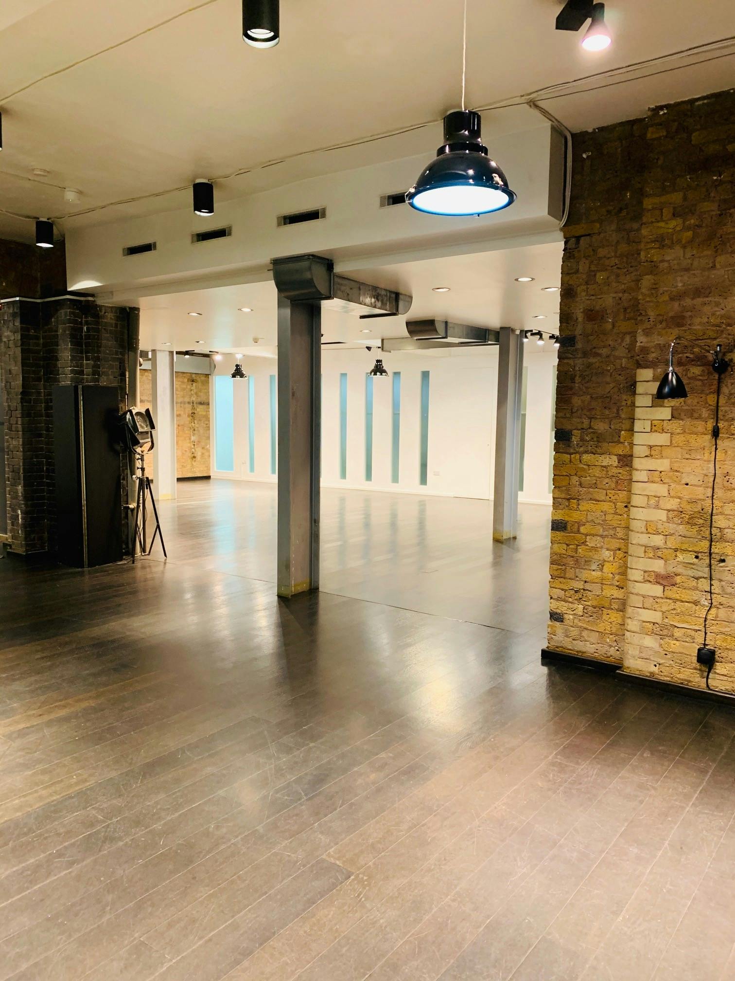 Versatile event space with polished wooden floors in Fitzrovia, ideal for meetings and gatherings.