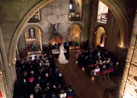 Intimate wedding ceremony at Mansion House, Hedingham Castle with elegant architecture.