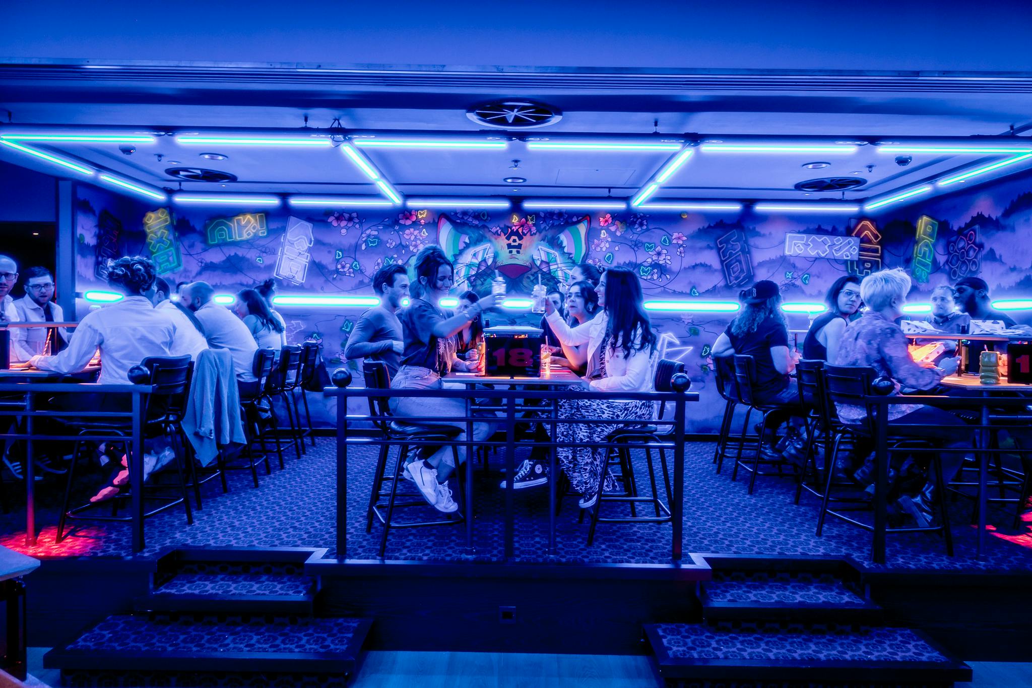 Vibrant event space with neon lighting for social gatherings and themed parties.