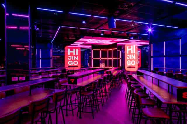 Vibrant event space in Hijingo with bold lighting for networking and product launches.