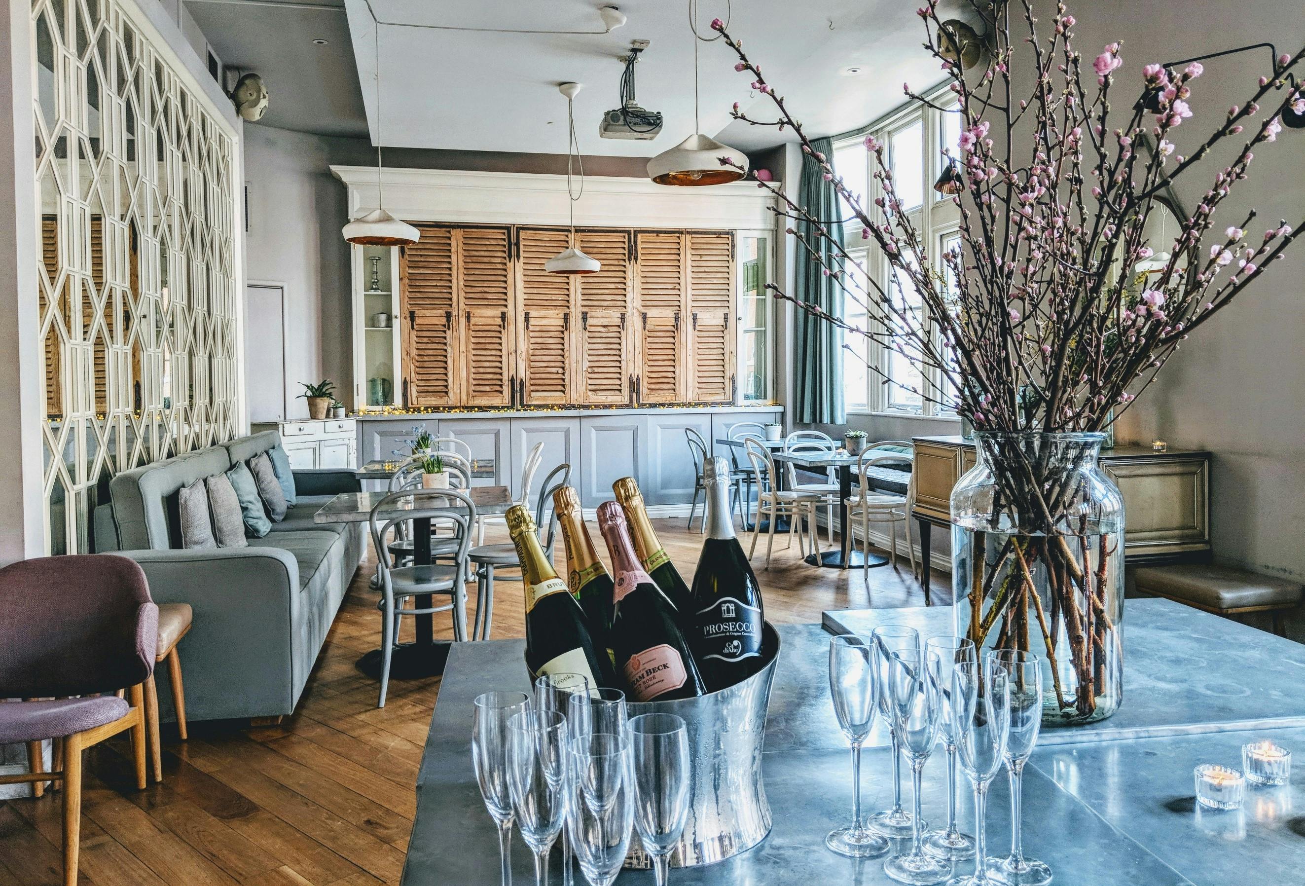 Chic event space with bar and champagne, perfect for networking or celebrations.