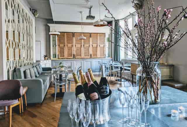 Chic event space with bar and champagne, perfect for networking or celebrations.
