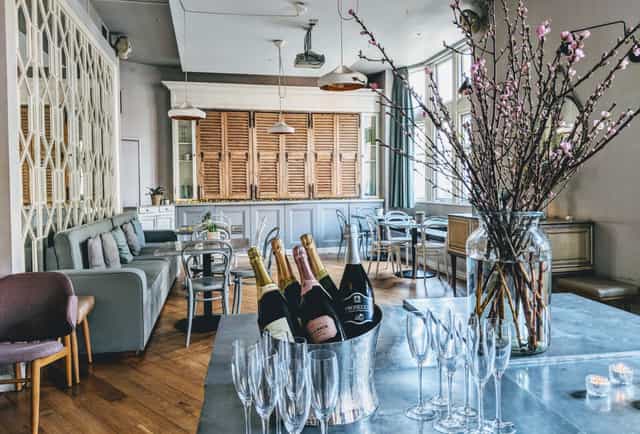 Chic event space with bar and champagne, perfect for networking or celebrations.