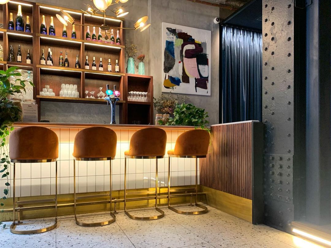 Stylish bar area at Exclusive Venue, perfect for networking events and gatherings. - Banner