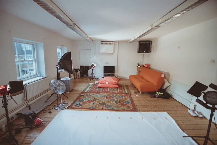 Versatile studio space with vibrant rug for intimate gatherings and creative meetings.